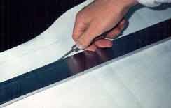 Scoring of completed parchment for Torahs, tefillin, mezuzahs and megillahs