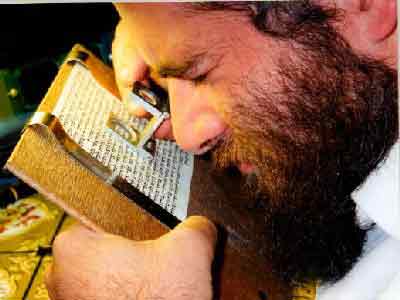 Examining a mezuzah scroll